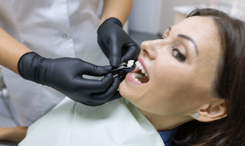 Dentist examining patient's teeth during same day crown procedure in Tempe dental office.