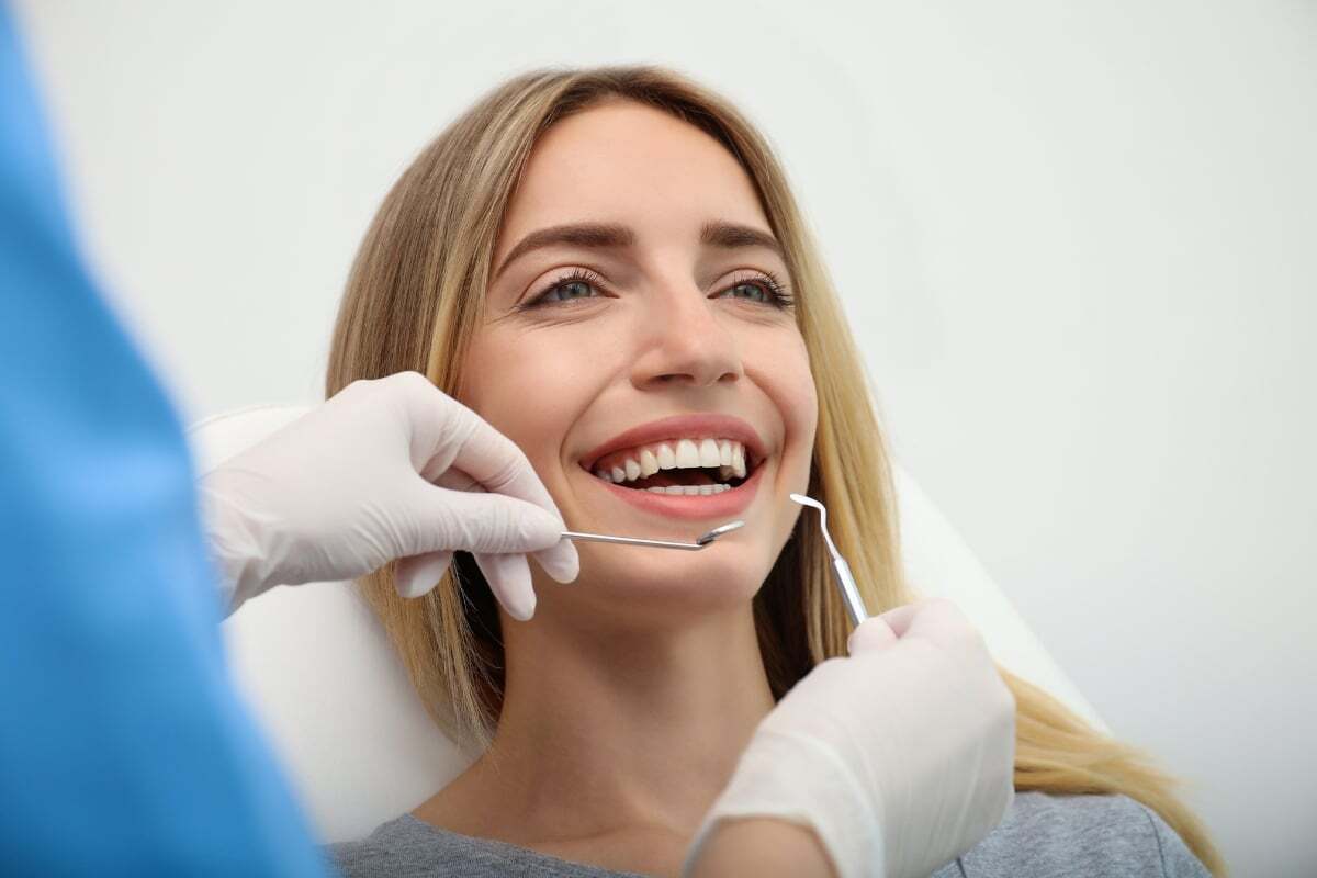 Happy patient smiling during dental examination with cosmetic dentist in Tempe.