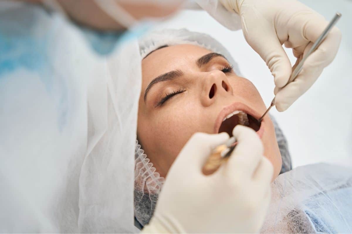 Dentist examining patient's teeth during routine dental checkup in Tempe.