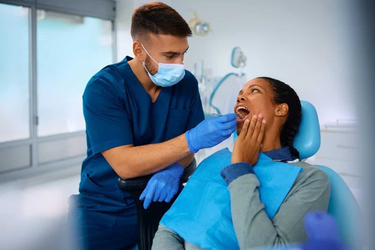 Dentist examining a patient's mouth during a dental checkup in Tempe.